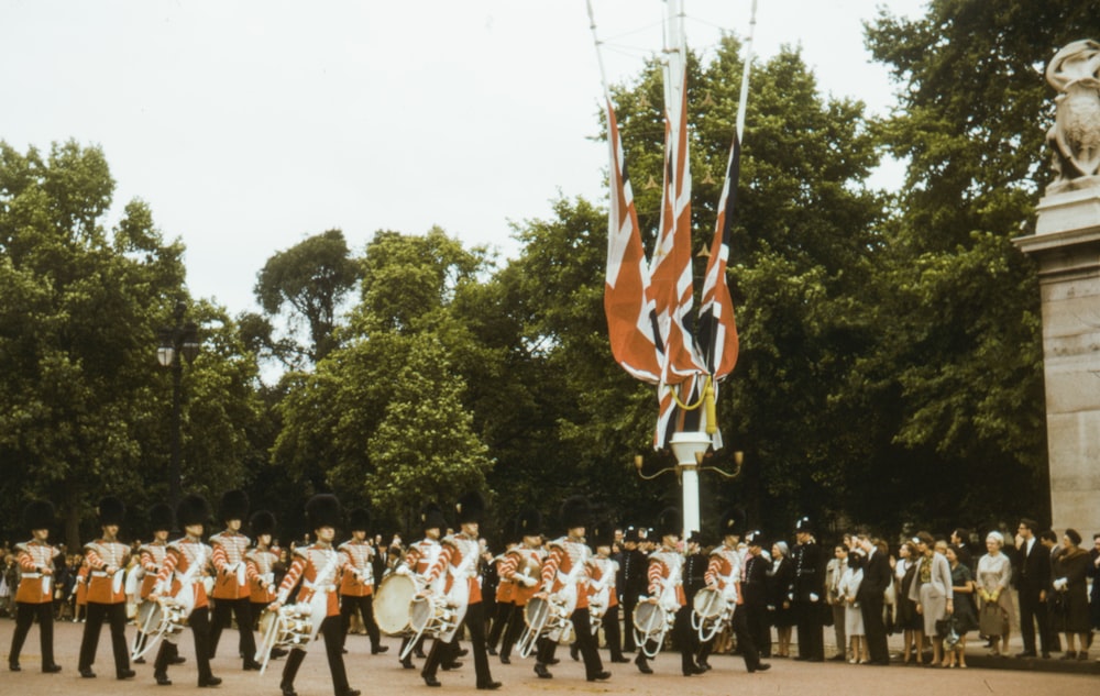 people in white shirts and red and white striped scarf