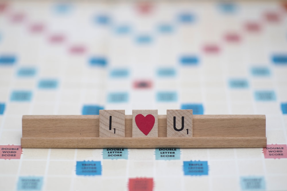 brown wooden blocks on white and red textile