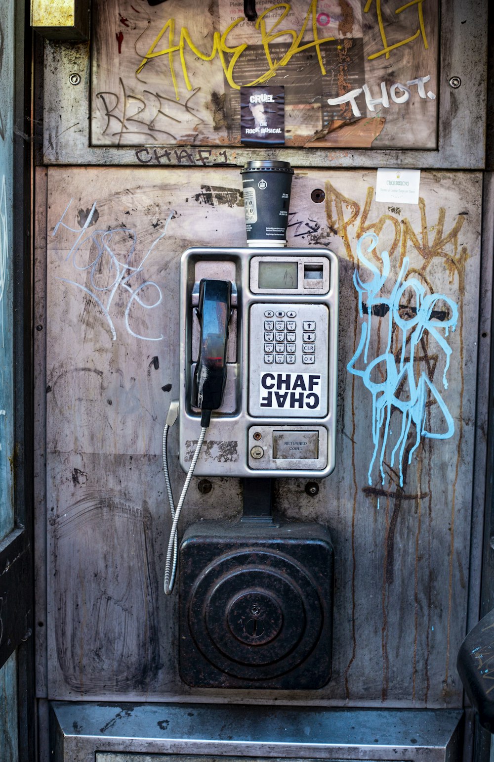 black and gray telephone on brown wooden wall