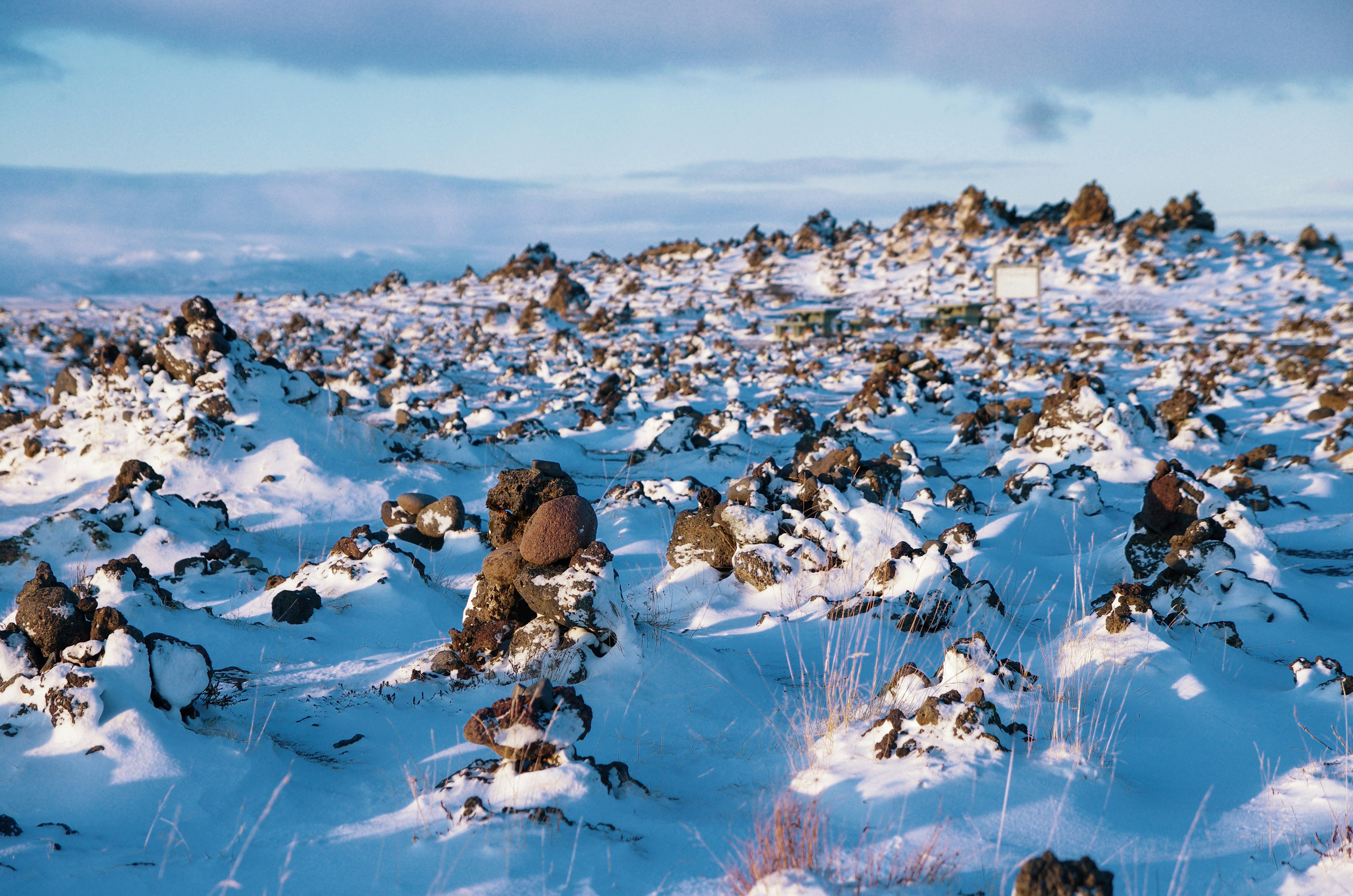 brown and white rocks on snow covered ground