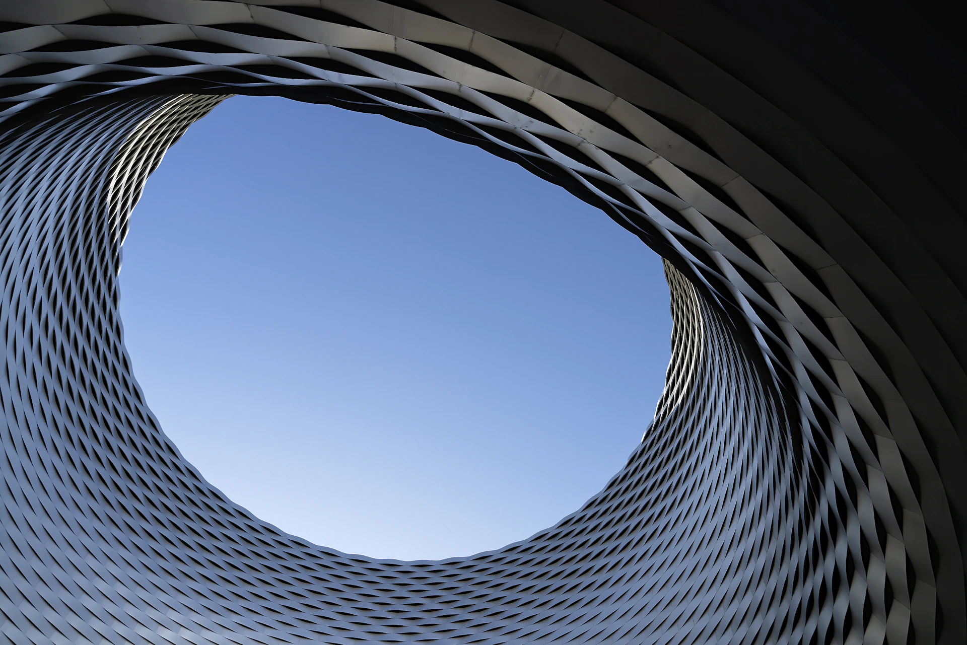 low angle photography of gray concrete building under blue sky during daytime