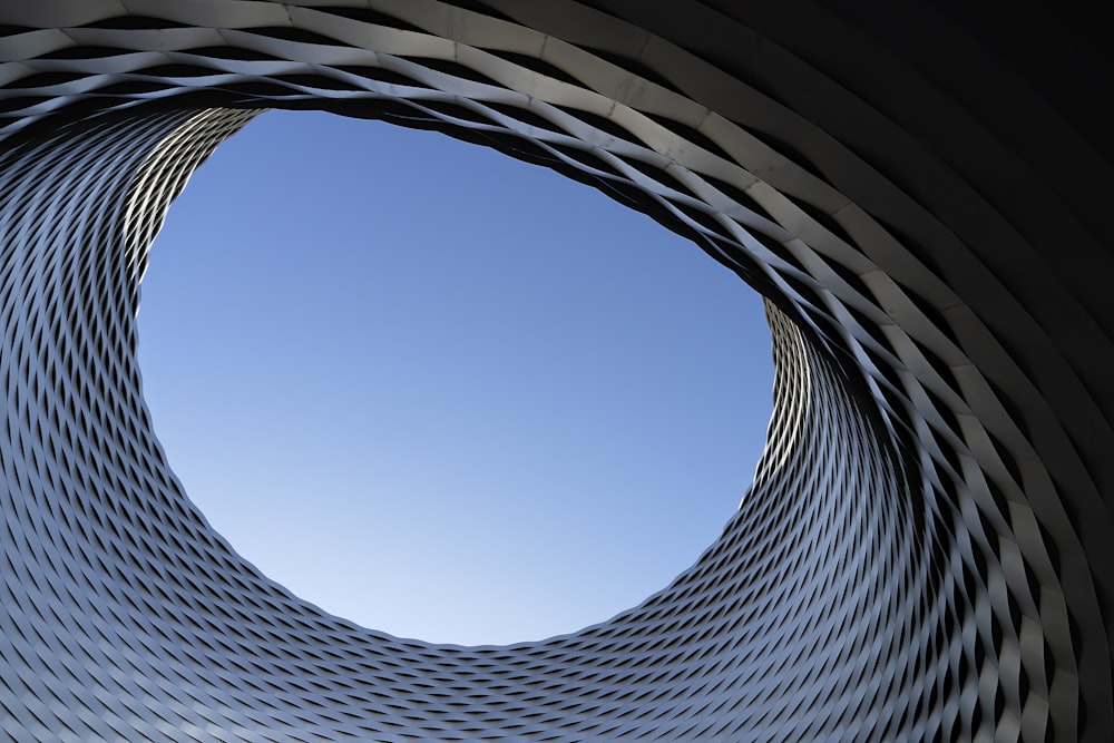 low angle photography of gray concrete building under blue sky during daytime