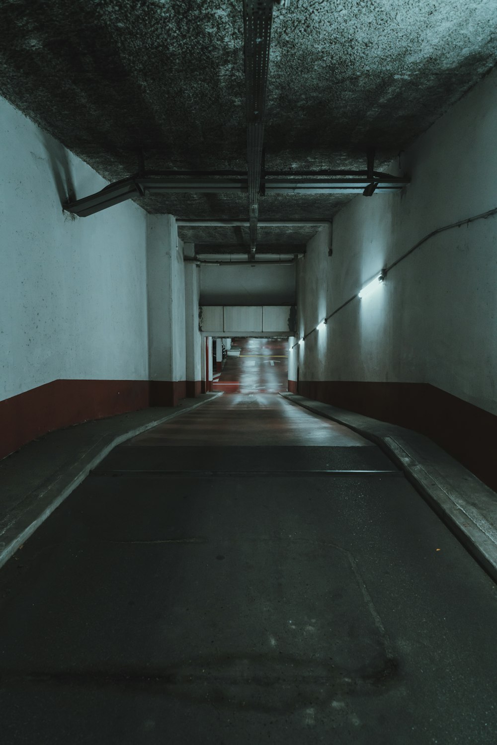 red and gray concrete hallway