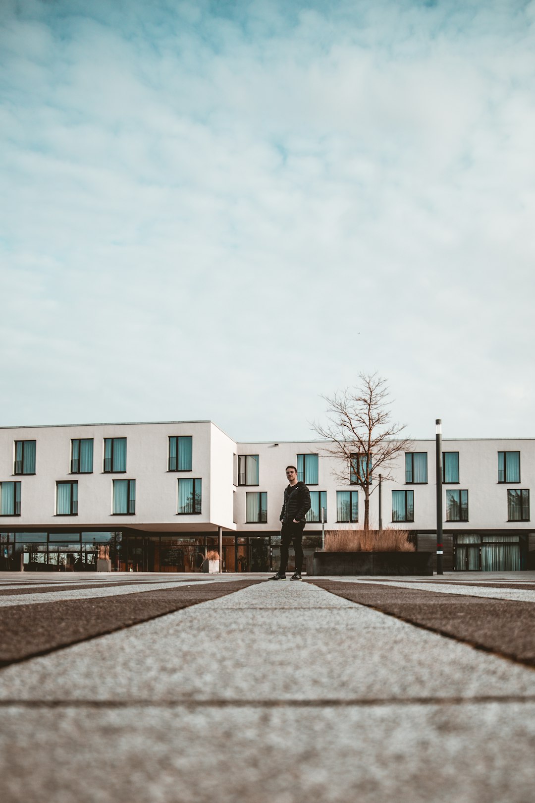 person walking on sidewalk near building during daytime