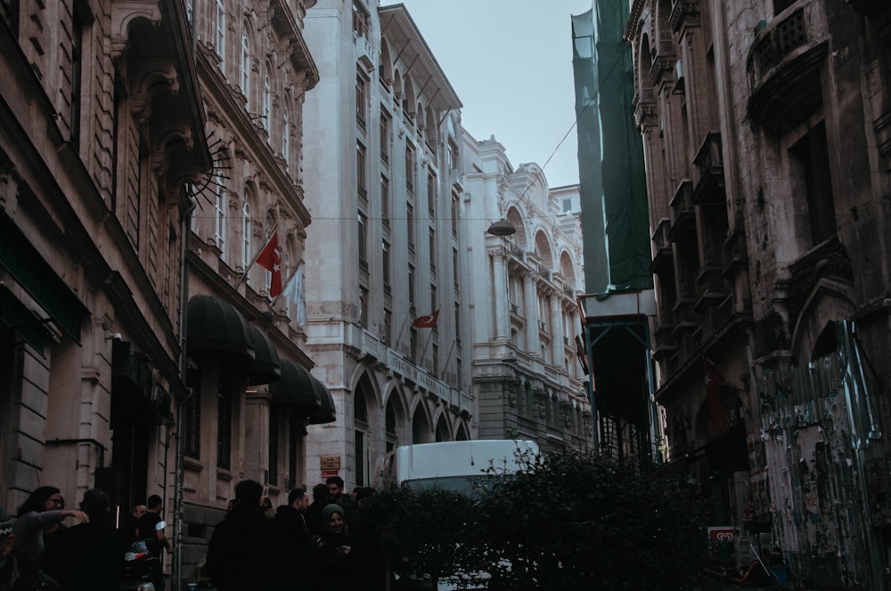 people walking on street between buildings during daytime