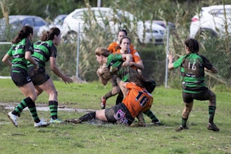 women playing rugby during daytime