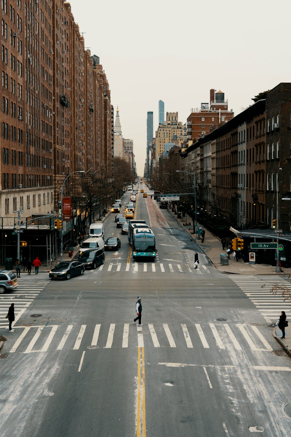 people crossing on pedestrian lane during daytime