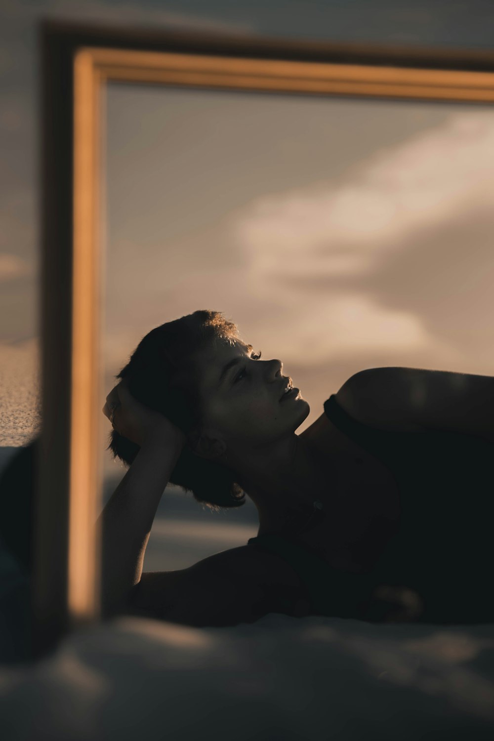 woman in black shirt leaning on window during daytime