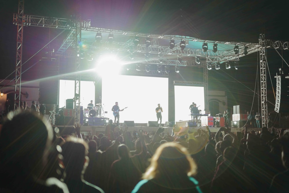 people standing on stage in front of crowd