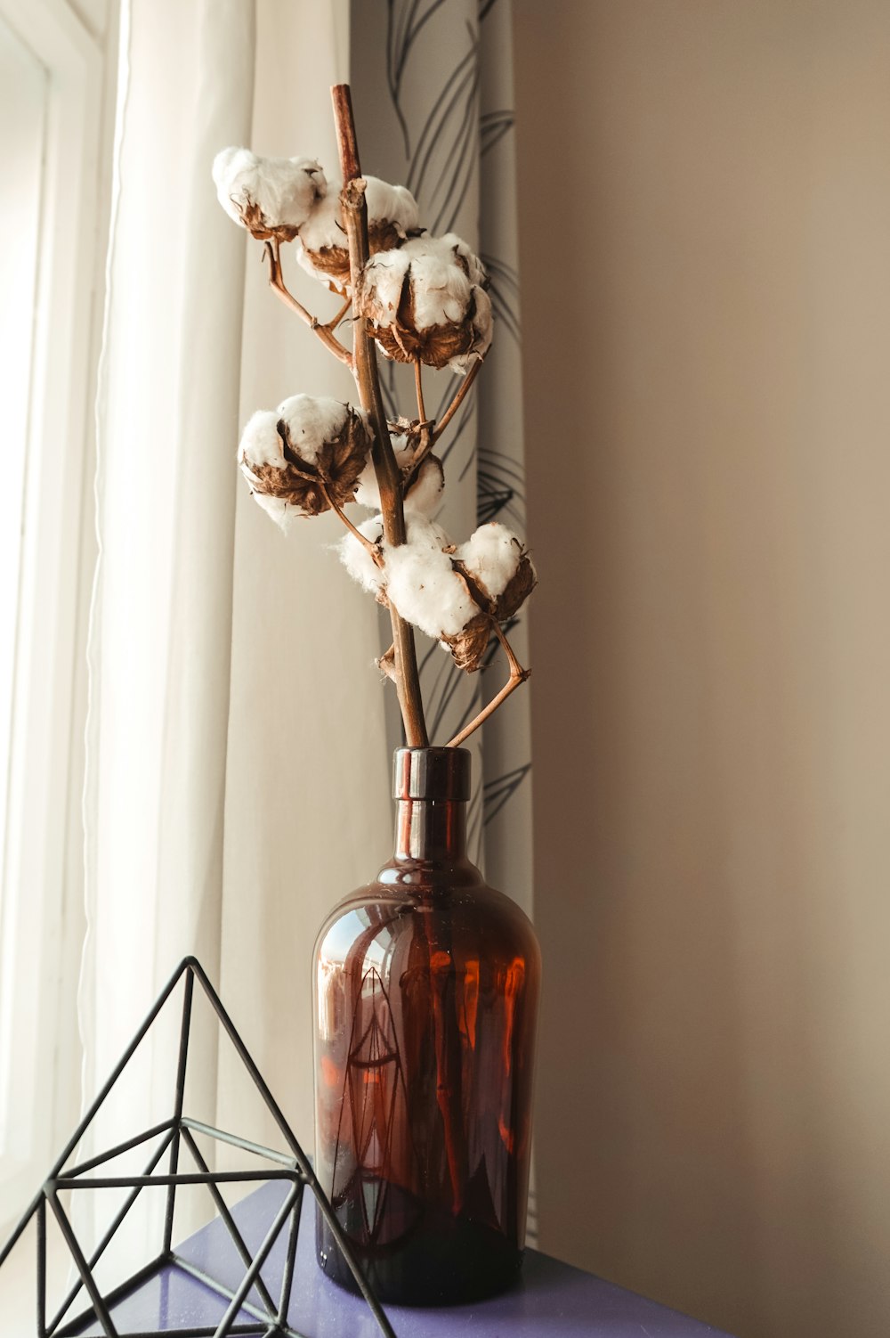 white flowers in red glass vase