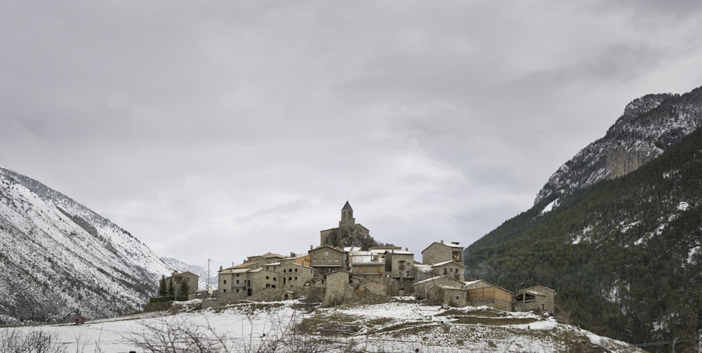 brown concrete building near green trees under white clouds during daytime