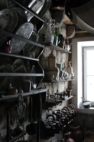 Rustic wooden shelves displaying handcrafted western decor pieces with warm lighting.