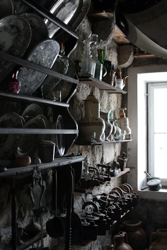 Rustic wooden shelves displaying handcrafted western decor pieces with warm lighting.