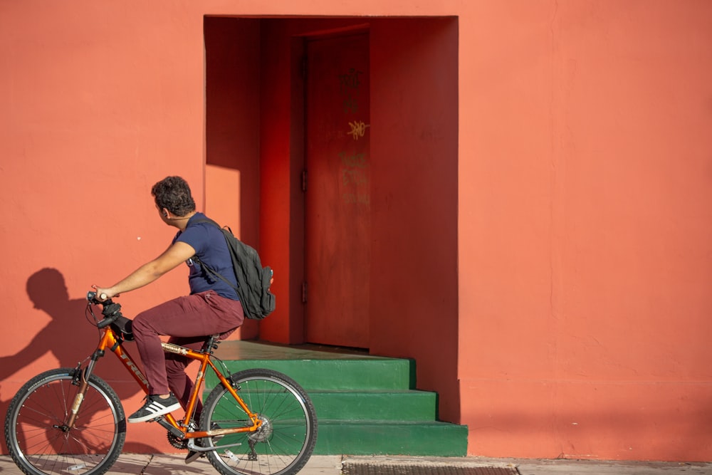 man in black t-shirt riding on bicycle