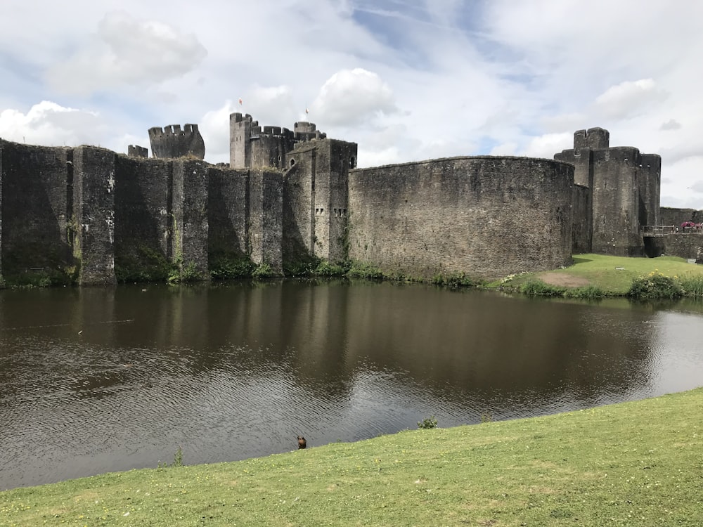 gray concrete building near body of water under blue sky during daytime