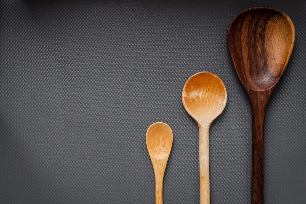 brown wooden spoon on gray textile