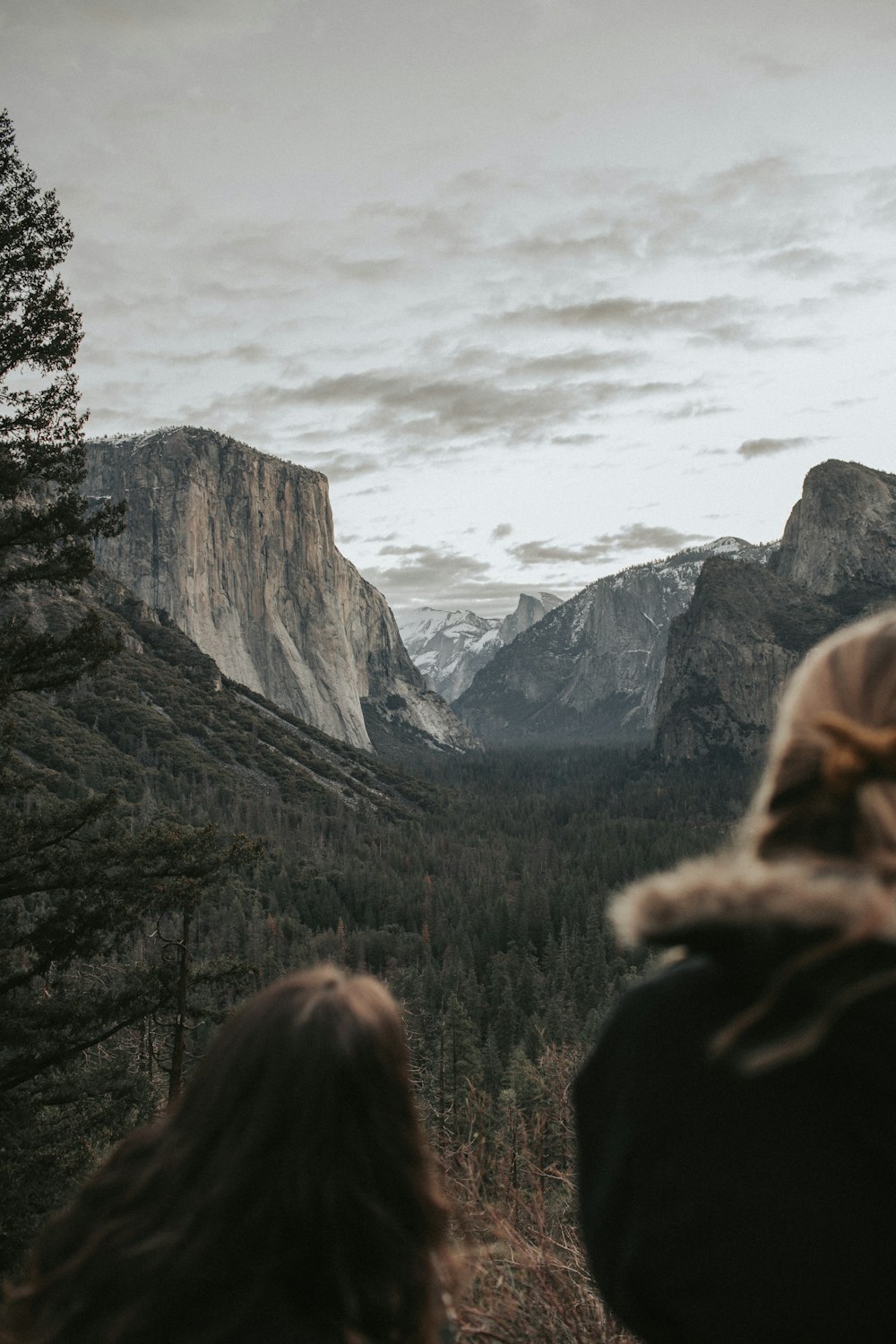 people walking on green grass field near mountain during daytime