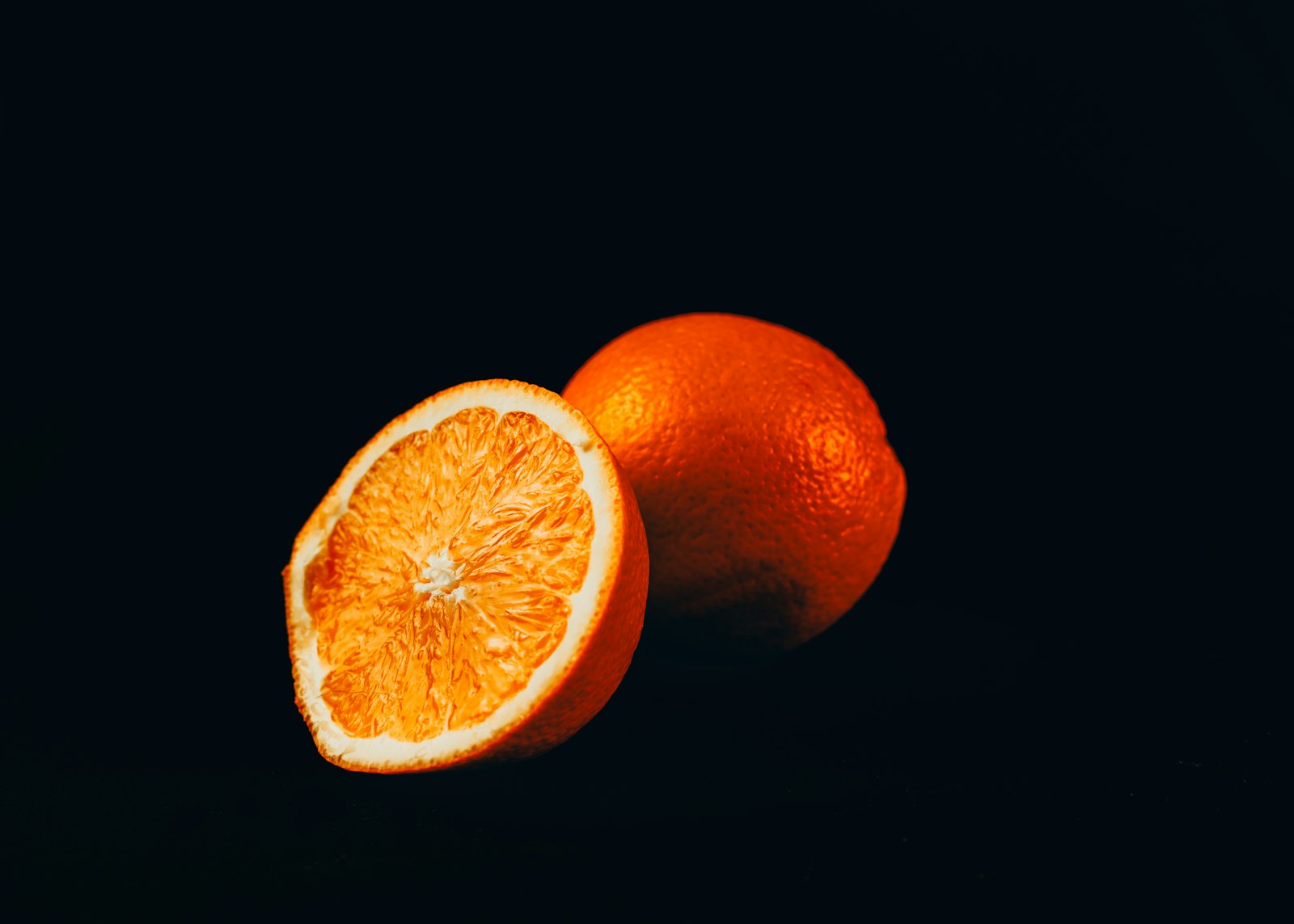 Nikon D800 + Nikon AF-S DX Nikkor 35mm F1.8G sample photo. Orange fruit on black photography