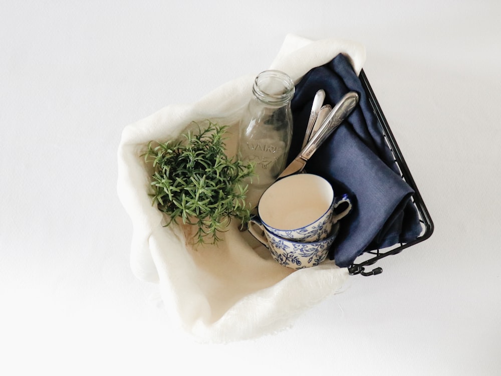 white rose bouquet beside white and blue floral ceramic teacup