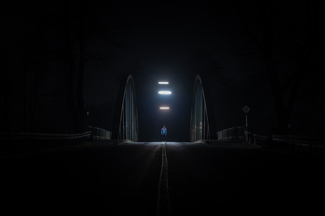 person walking on road during night time