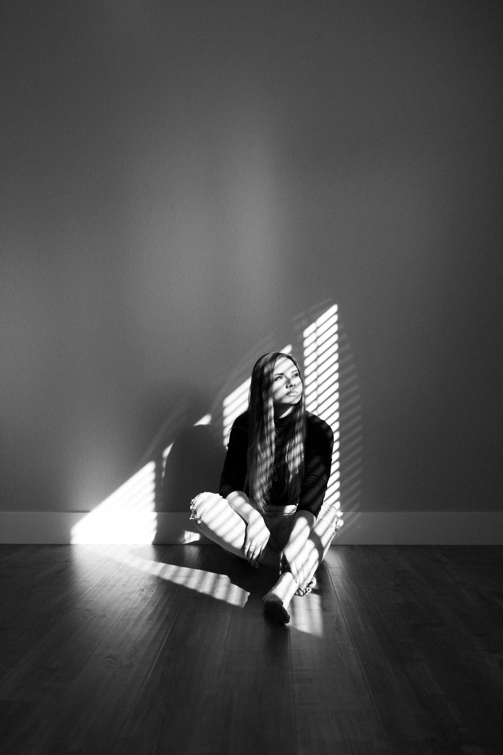 woman in black and white stripe long sleeve shirt sitting on floor