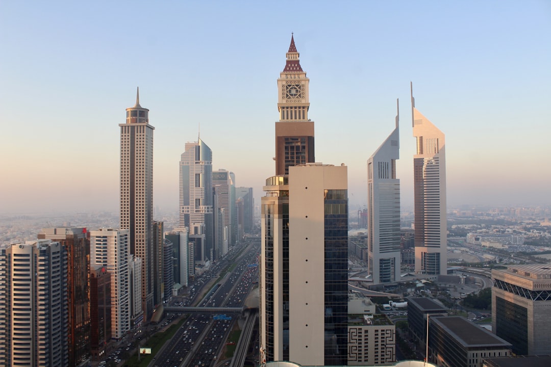 city buildings under blue sky during daytime, Scene from Gevora Hotel, 79th floor. It was taken during golden hour in Dubai, UAE.<p></figure>