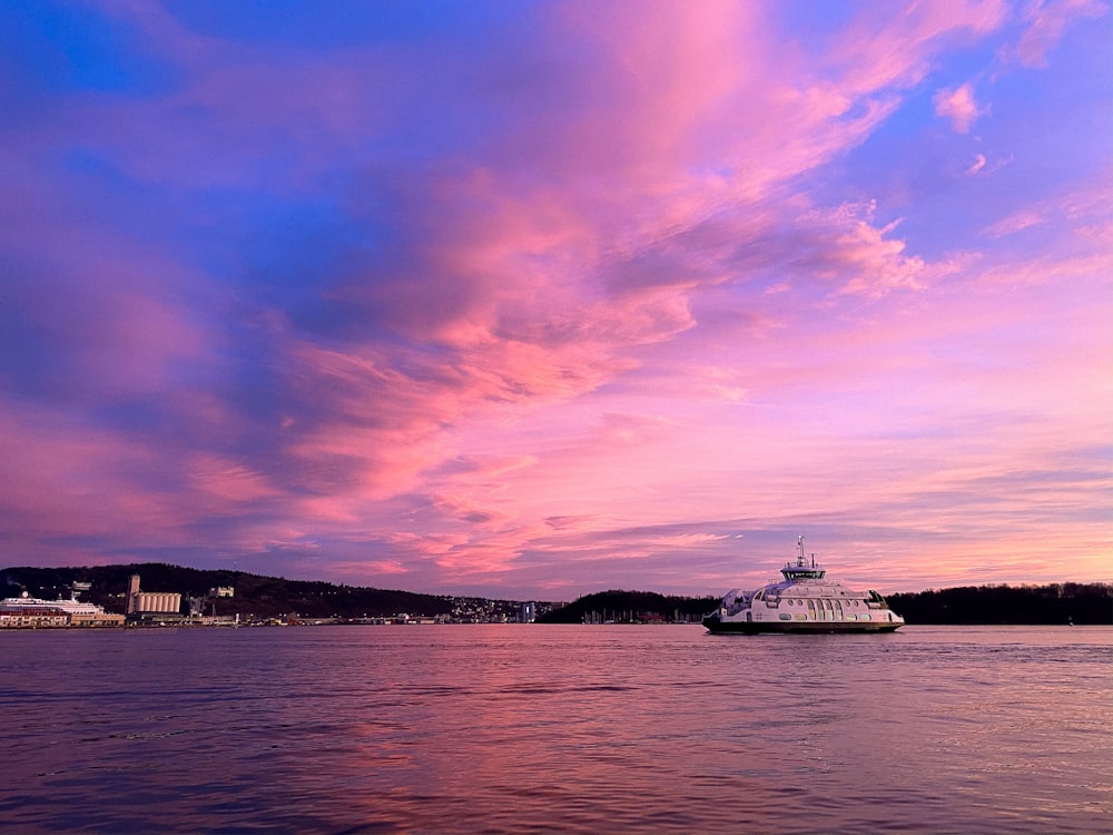 white ship on sea under cloudy sky during daytime