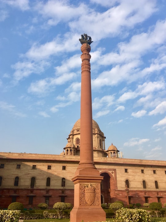 brown concrete building under blue sky during daytime in Rashtrapati Bhavan India