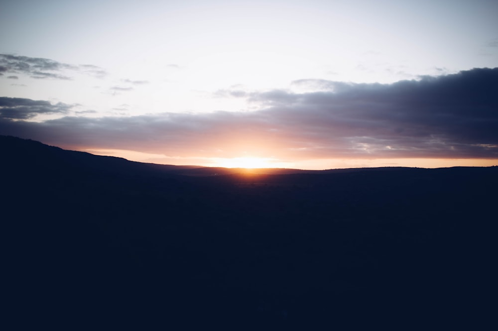 silhouette of mountain during sunset