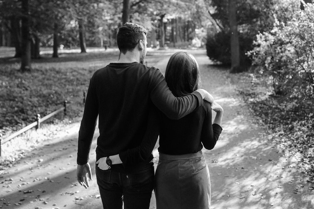 man and woman kissing in grayscale photography