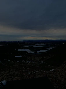 A sweeping landscape shot at dusk, highlighting vastness and mystery.