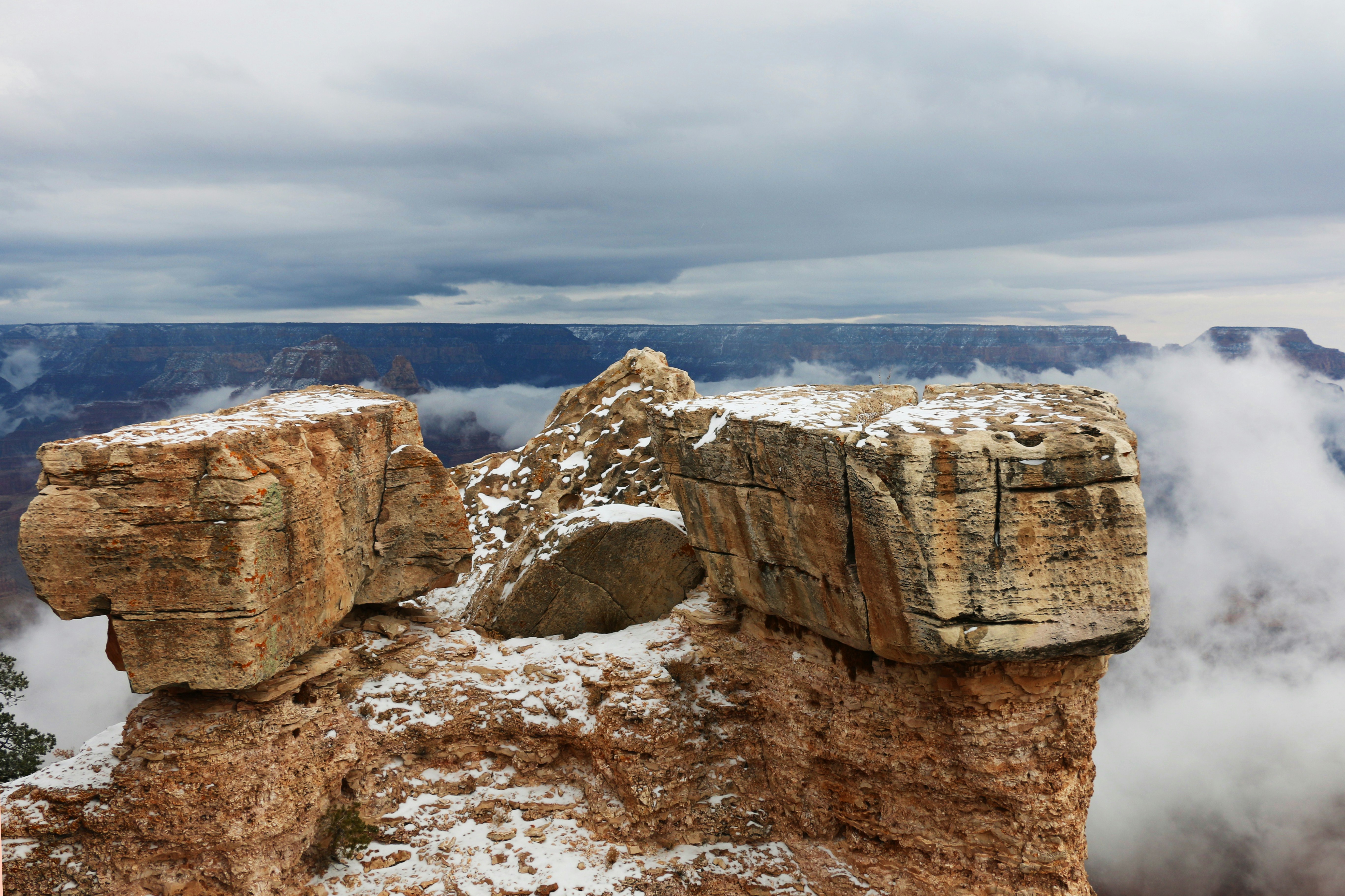 brown rock formation under white clouds during daytime