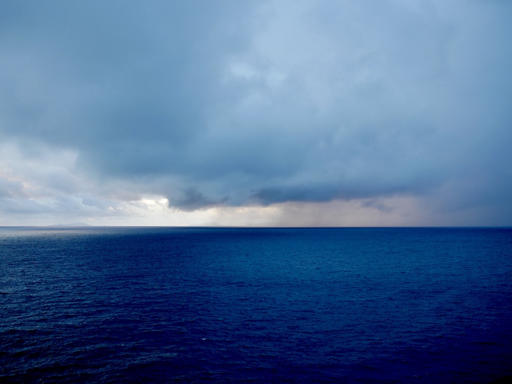 blue sea under white clouds during daytime