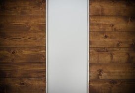 brown wooden drawer beside white wall
