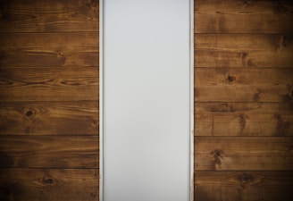 brown wooden drawer beside white wall