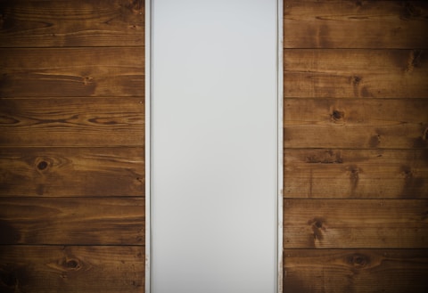 brown wooden drawer beside white wall