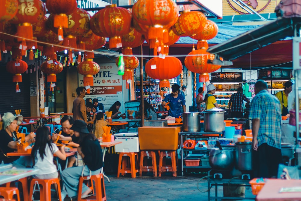 people sitting on brown wooden chairs