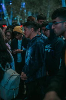 A vibrant group of friends wearing matching custom club hoodies in a lively urban setting