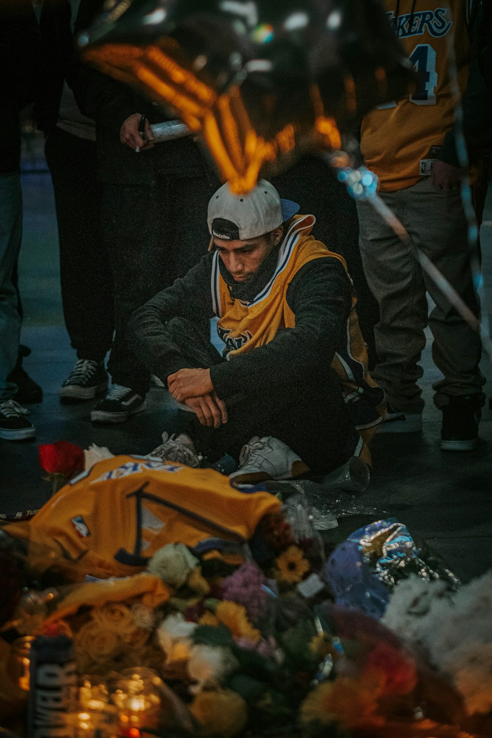 man in black jacket sitting on floor