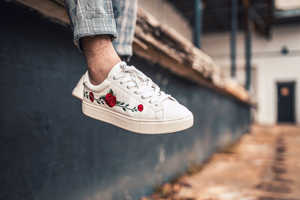 person wearing white nike air force 1 low