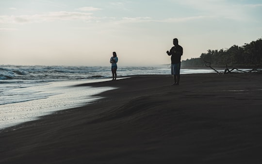 man and woman standing on beach during daytime in Tortuguero Costa Rica