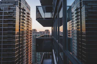 A high-rise downtown condominium with balconies and panoramic city views during sunset.