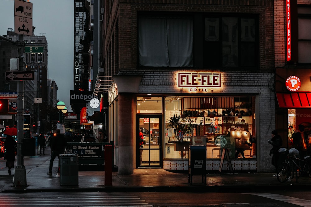 brown and black store front during nighttime