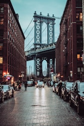 people walking on street near bridge during daytime