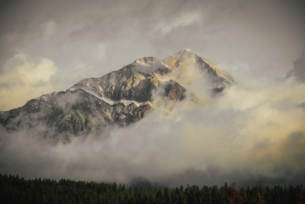 snow covered mountain under cloudy sky during daytime