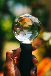 Close-up of hands holding a vibrant crystal.