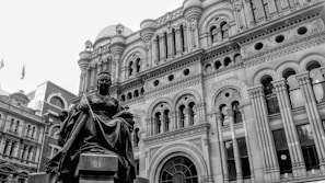 A candid self-portrait of Praveen Madaan smiling against a backdrop of ancient architecture