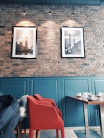 A panoramic view of the cafe’s interior showcasing dark walls, red accents, and subtle gold details.