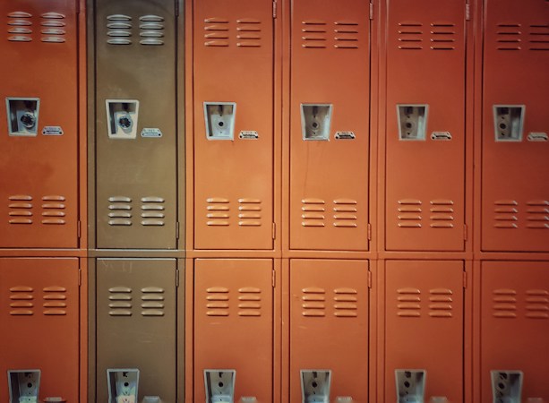A blue metal locker secured with a padlock, a reminder that locked storage at home is a simple safety step for families with kids