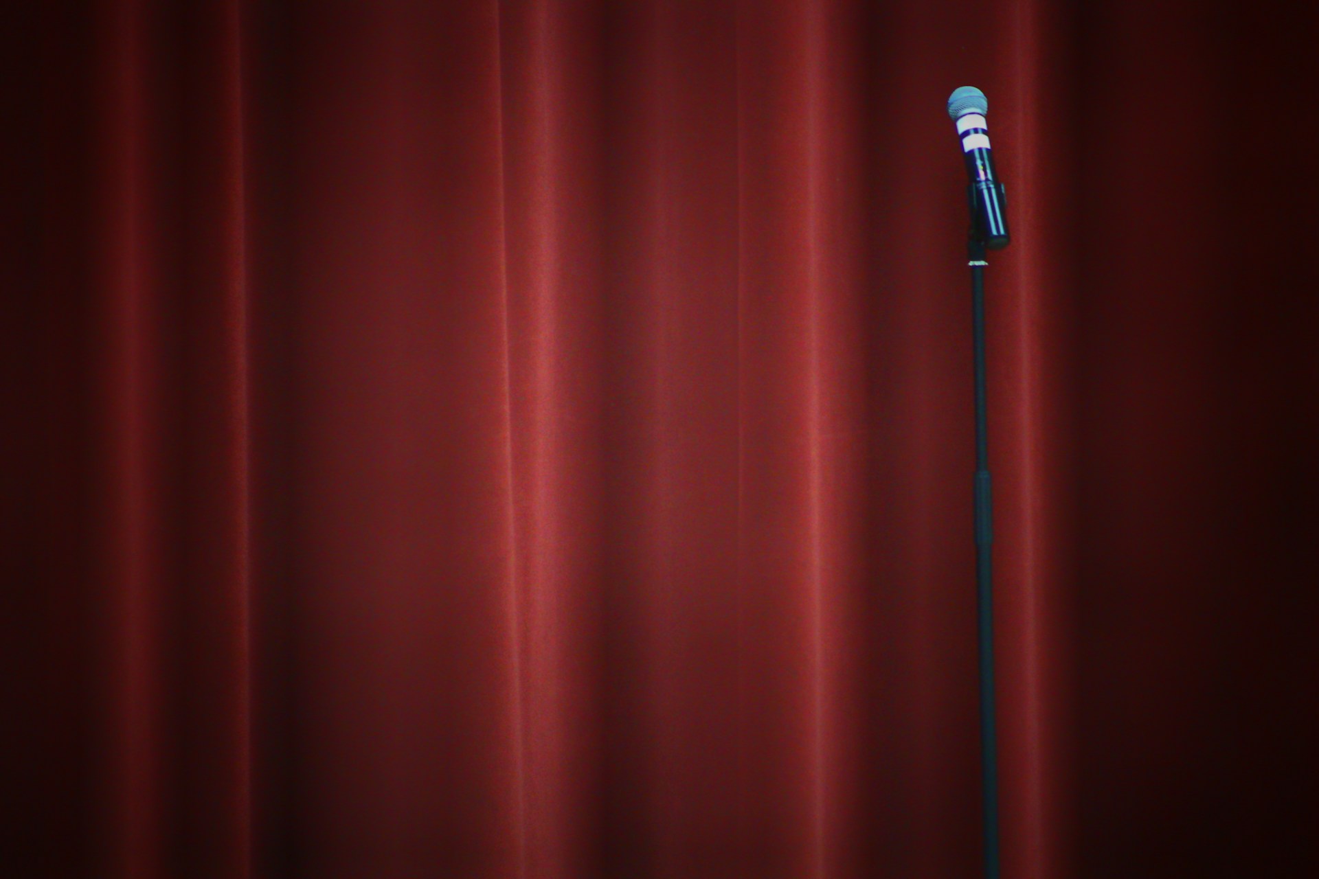 black microphone on red curtain